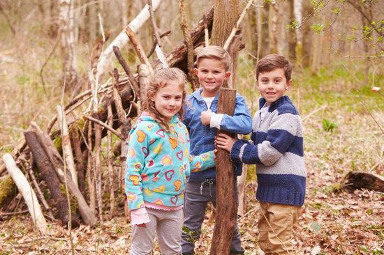 Children Building Camp In Forest Together